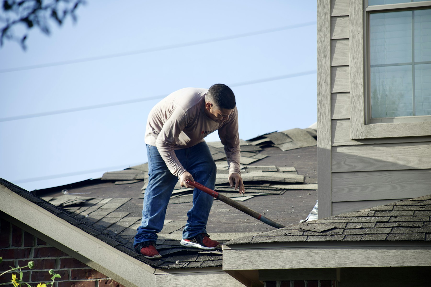 Roofing professional working on residential shingles